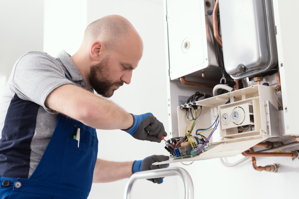 HVAC technician performing a heating repair service on a boiler 