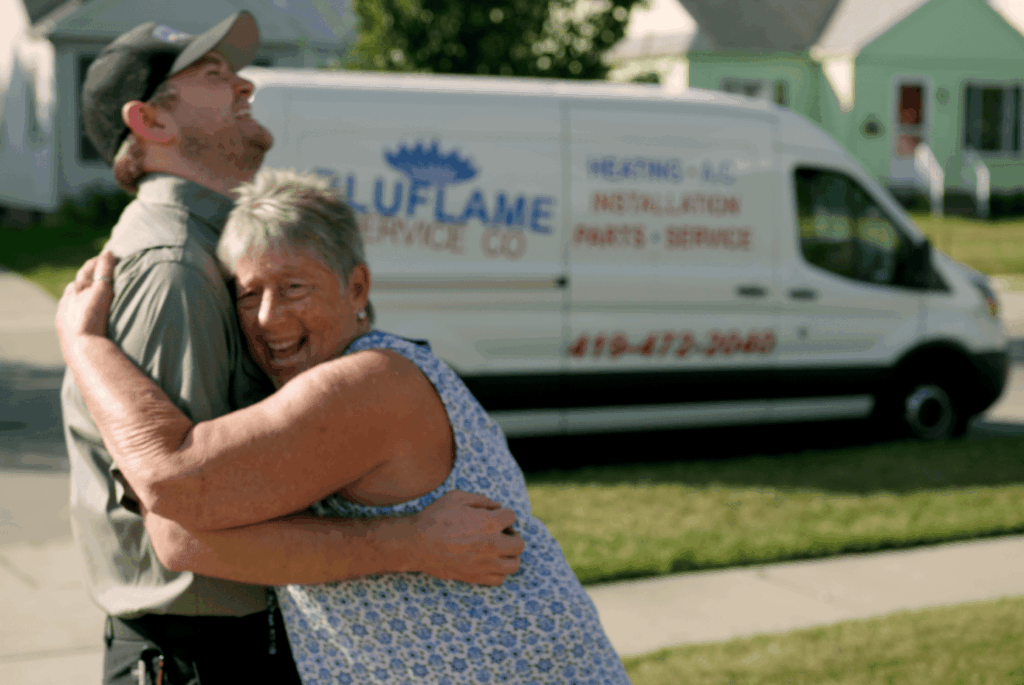 Bluflame customer hugging tech - both laughing