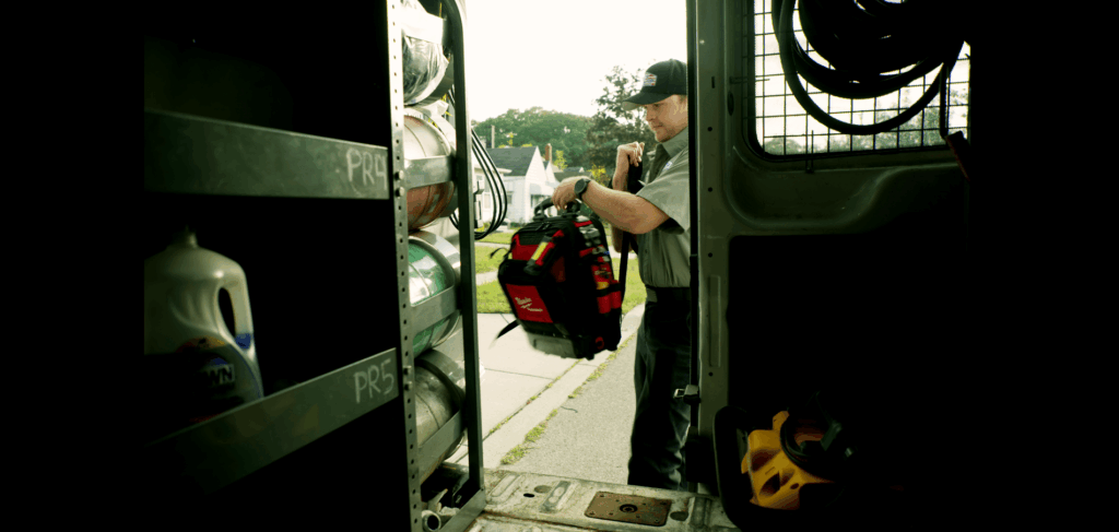 Bluflame tech grabing bookbag from back of van