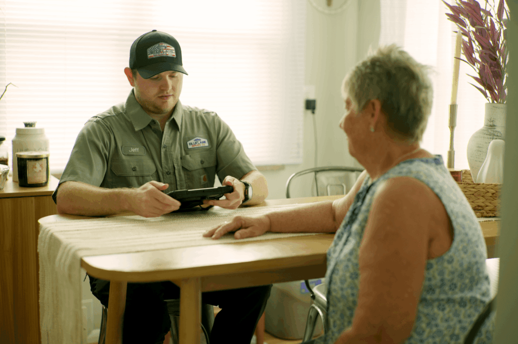 Bluflame tech with customer on tablet